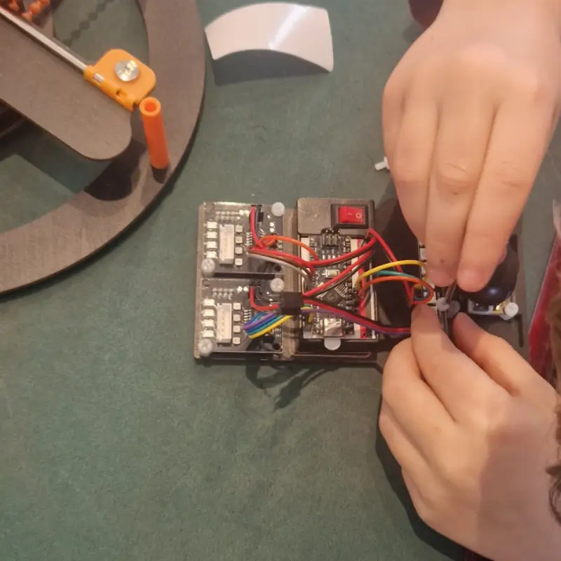 Hands wiring electronics — real engineering with young people